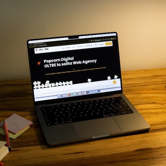 Laptop displaying Metal Studio website mockup with minimalist black and white design on modern curved surface with "MOCKUP" text prominently shown